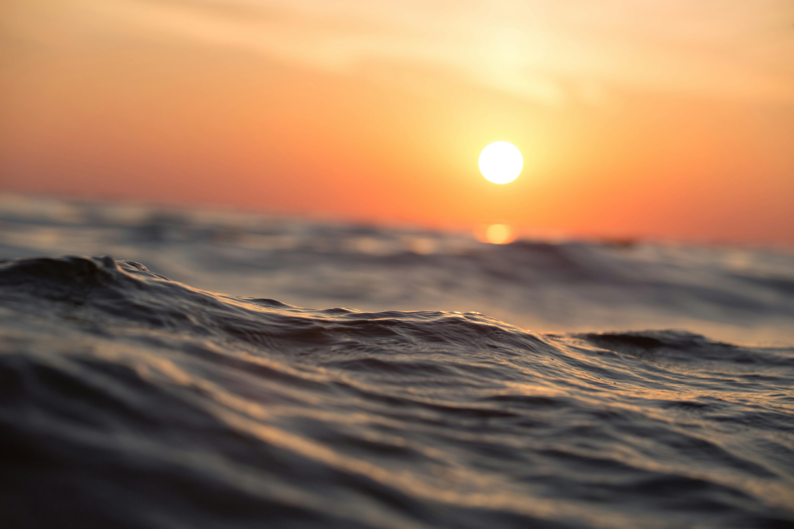 photo of sunrise over ocean water